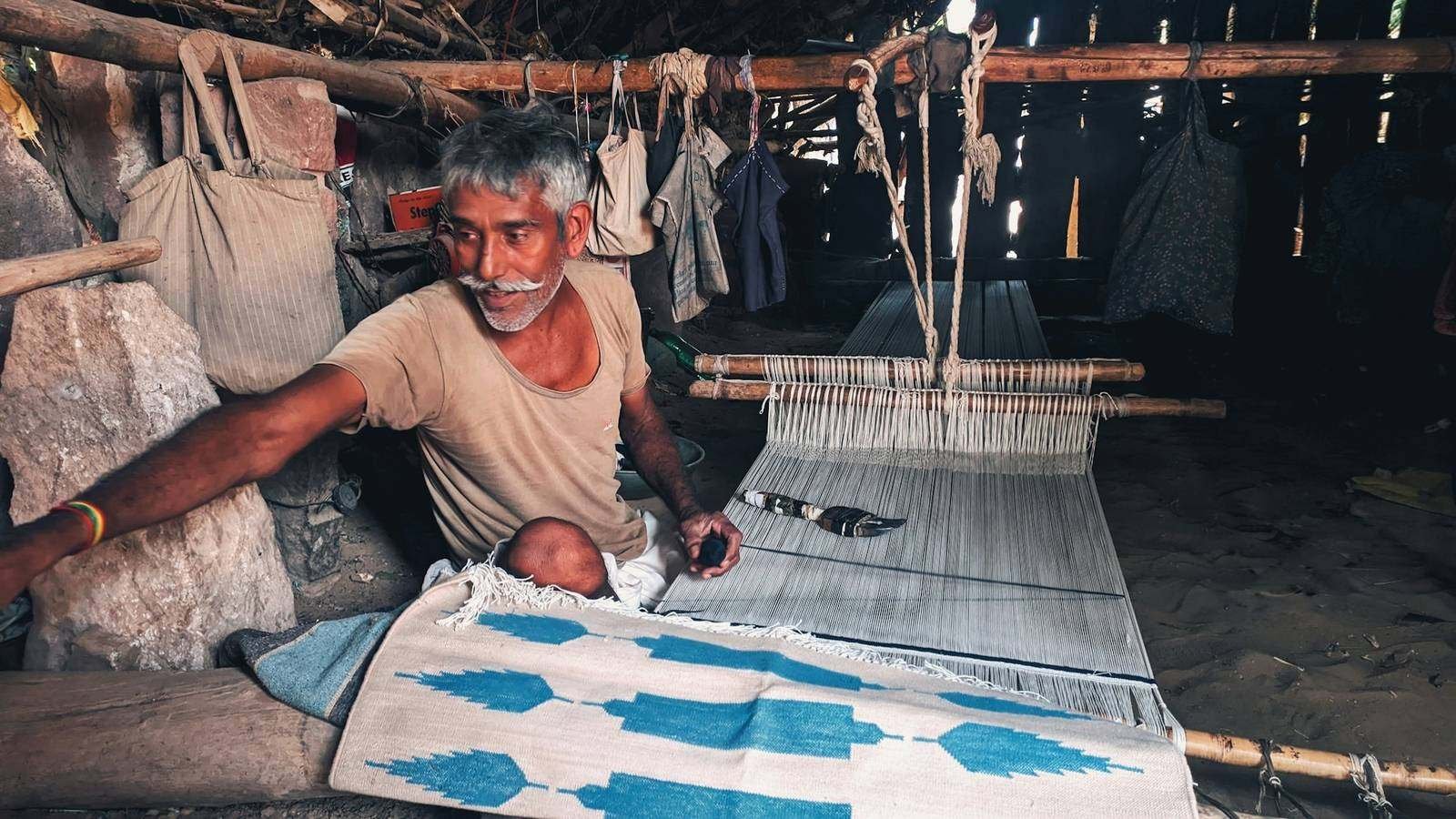 Weaver at a handloom with a block-printed textile