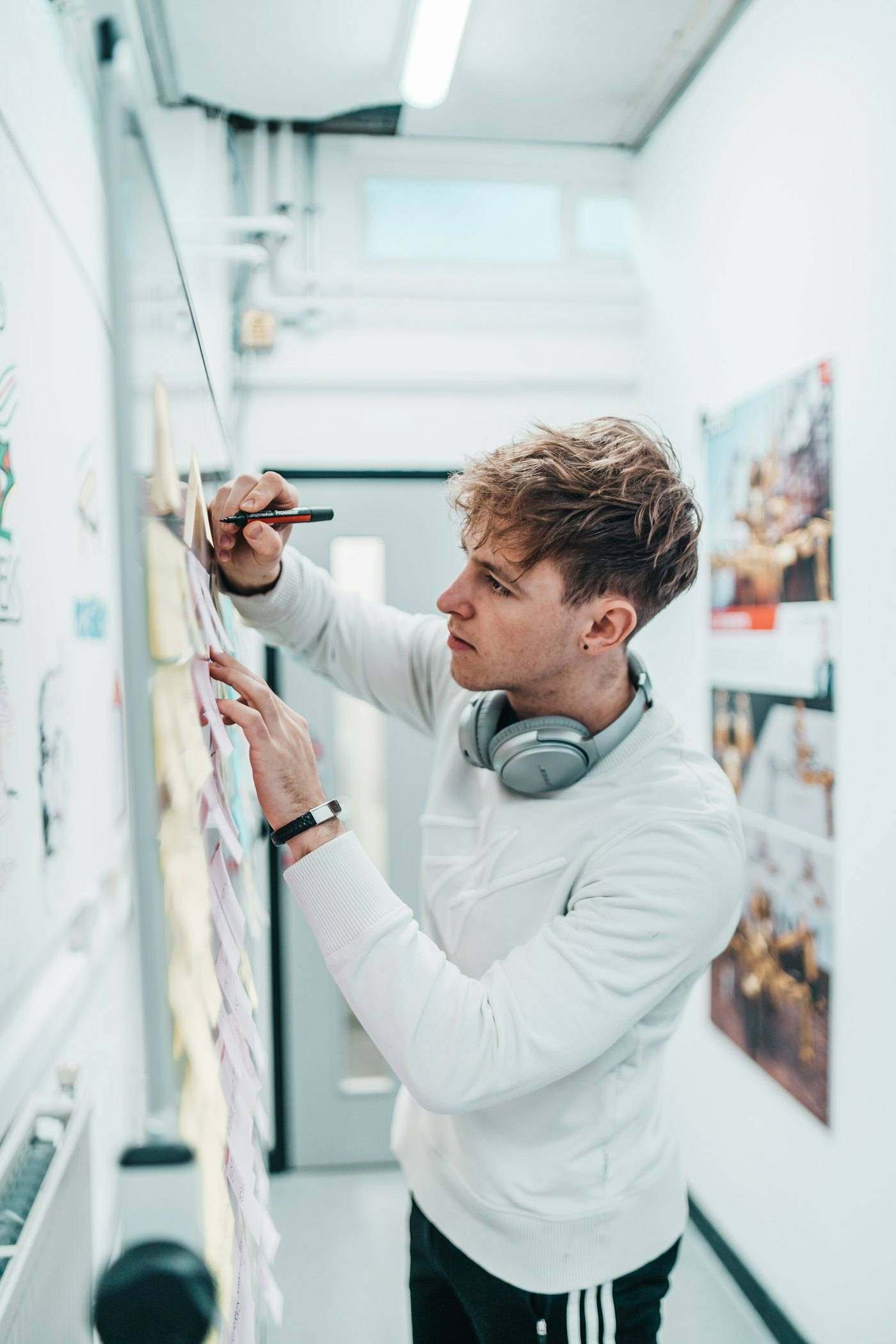 Designer pinning drawings to a studio wall