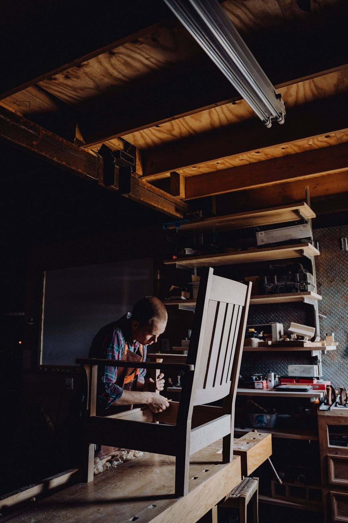 Furniture maker building a chair in a workshop