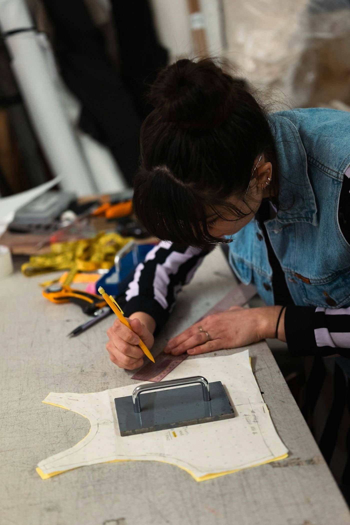 Design student drawing at a studio worktable
